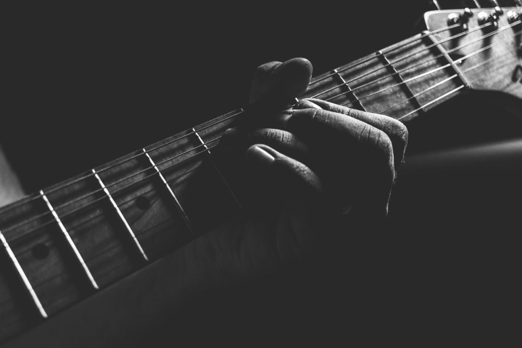 Hand on guitar strings