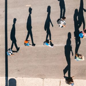 Shadows shaped like people on a sidewalk