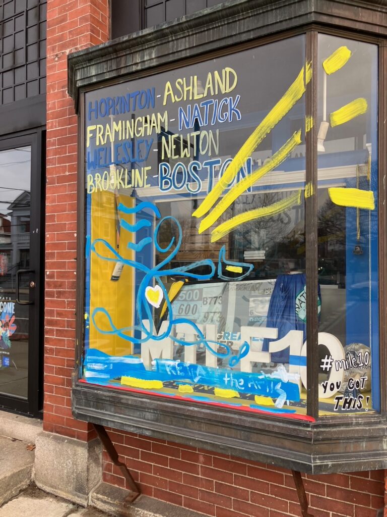Shop window painted in blue and yellow lettering