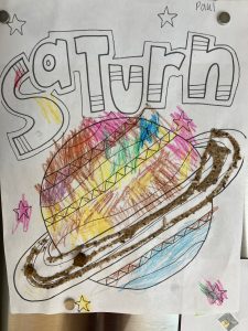 Child's coloring of the planet Saturn in many colors