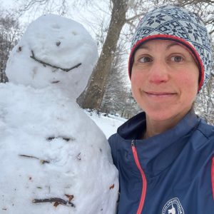 person next to a snow man